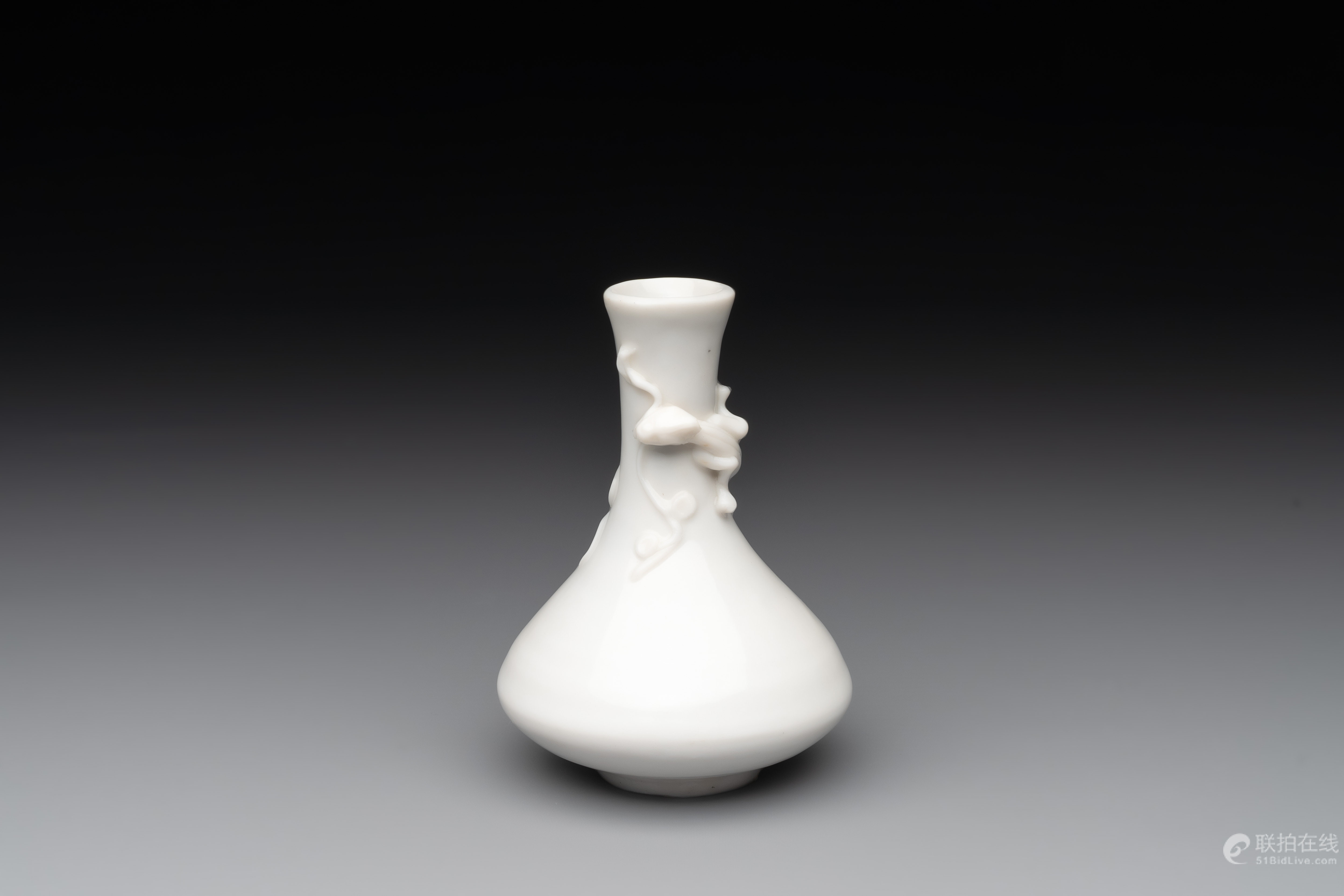 A small Chinese Dehua blanc de Chine 'dragon' bottle vase, Kangxi