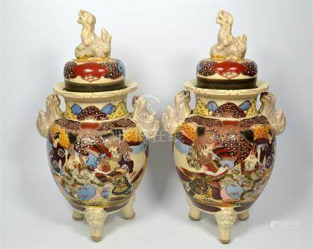  A pair of Japanese Satsuma vases with covers, painted with warriors and nobles