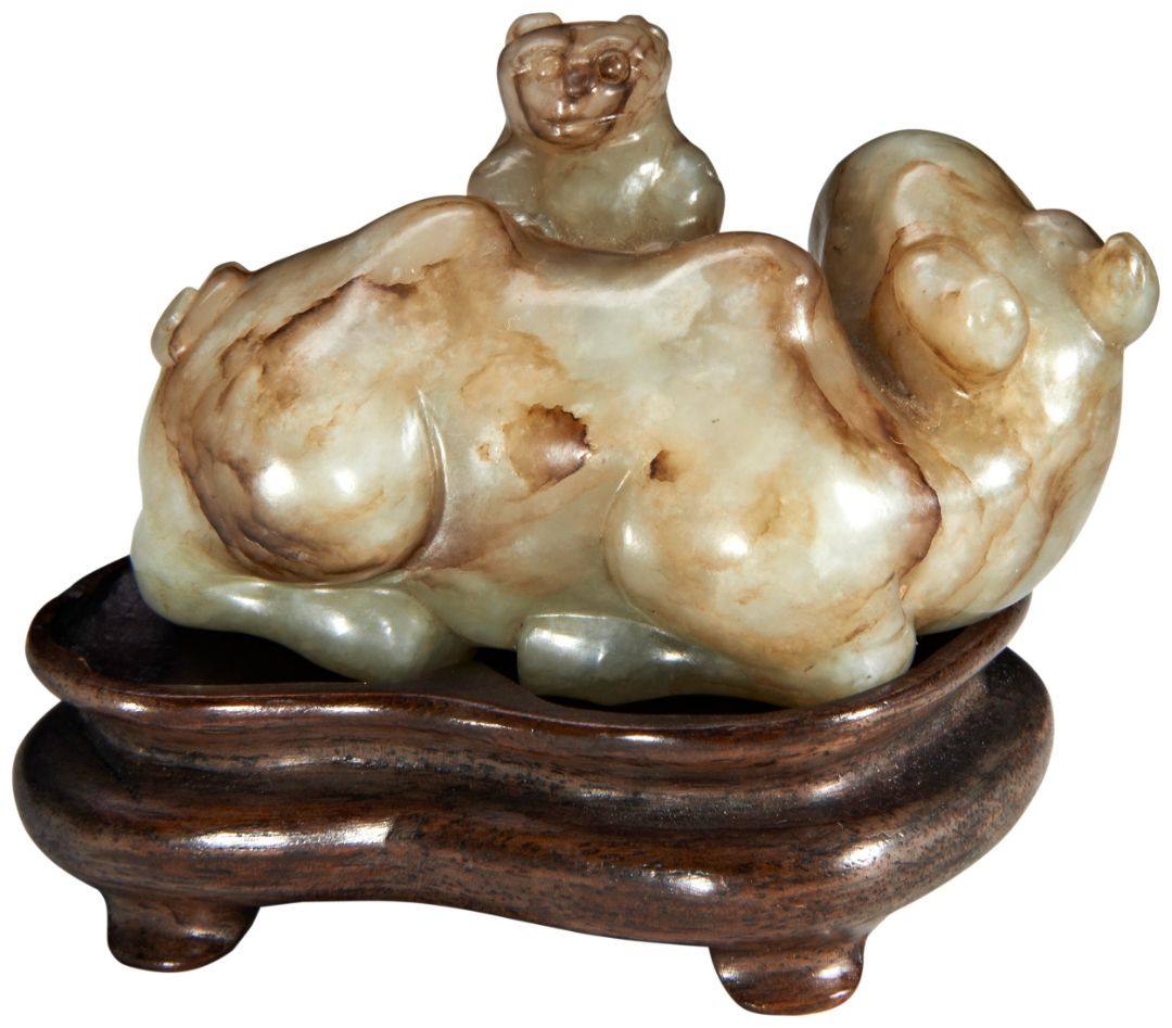 A CARVED PALE-GREEN AND BROWN 'CAMEL AND LION' GROUP MING DYNASTY (1368-1644) 青褐玉雕骆驼及犬摆件 明 1368-1644