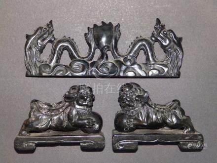  A small pair of Chinese black soapstone Lions and a brush rest (?). (3)