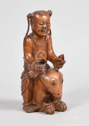  A 19c carved hardwood figure of Nezha originating from similar of the Shang Dynasty, 9in h.