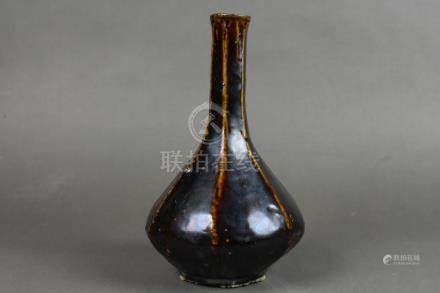 A black-glazed wine bottle