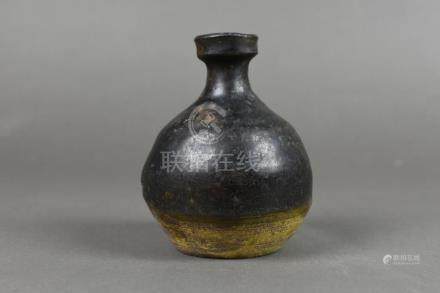 A black-glazed bottle