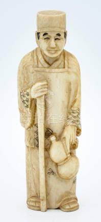 A Japanese Carved Ivory Okimono a Figure with a Cantine, Ear