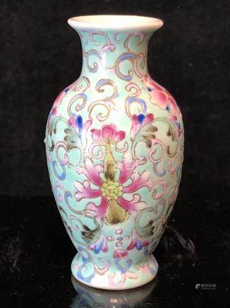  A miniature Chinese famille rose porcelain baluster vase, decorated with scrolling peonies on a pale