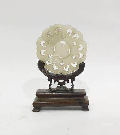  Chinese carved mutton fat jade medallion, stylised flowerhead pattern with revolving circular