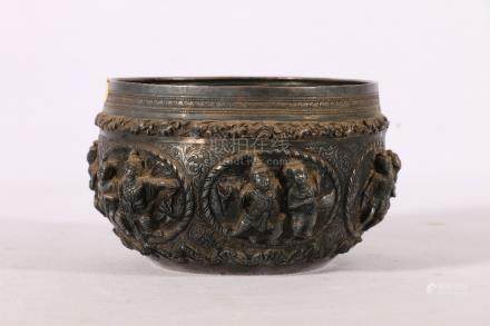  White coloured metal bowl of South East Asian design with six figure panels in high relief on a