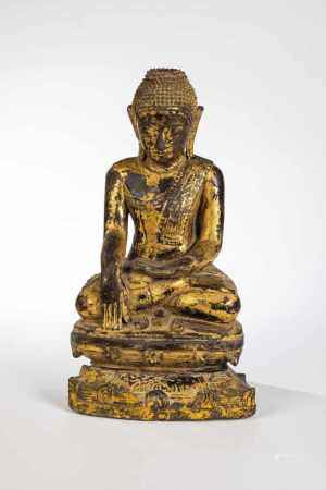 Buddha. Tibet 19th century. Buddha enthroned. Wood with gilding remains. 30 cm high.Damaged.