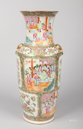 An early 19th century Cantonese floor vase. With moulded gilt mask handles and painted with lotus