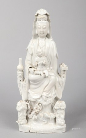 An 18th century Chinese blanc de chine statue of Guanyin and acolytes. Surrounded by precious