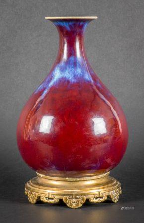 Porcelain and oxblood enamel piriform vase, lavender blue flames on the base and the neck openi