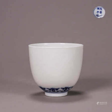 A dragon carved blue and white porcelain cup