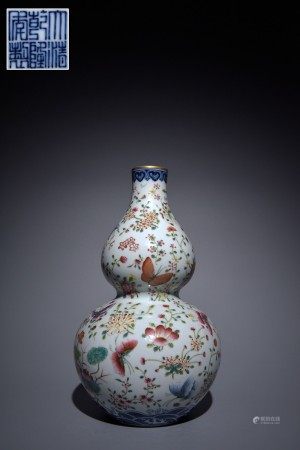 A Chinese Fencai butterfly flower gourd bottle