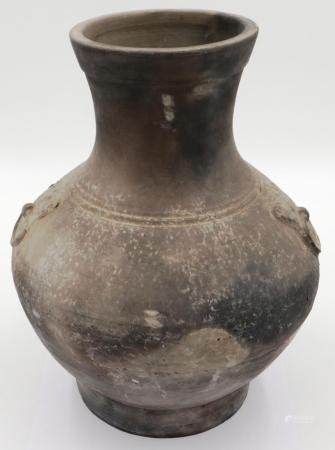 An early Qing Dynasty grey clay jar, baluster form with integral faux ring handles, footed