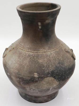 An early Qing Dynasty grey clay jar, baluster form with integral faux ring handles, footed