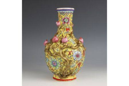 A Chinese porcelain yellow ground Magnolia vase, Qianlong seal mark, the bottle shaped tri-lobed