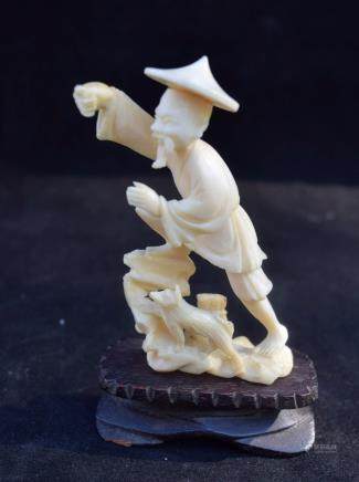 A CARVED FISHERMAN STATUE