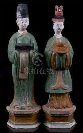  A pair of Chinese sancai glazed figures, the largest 48.5 cms (19ins) high.